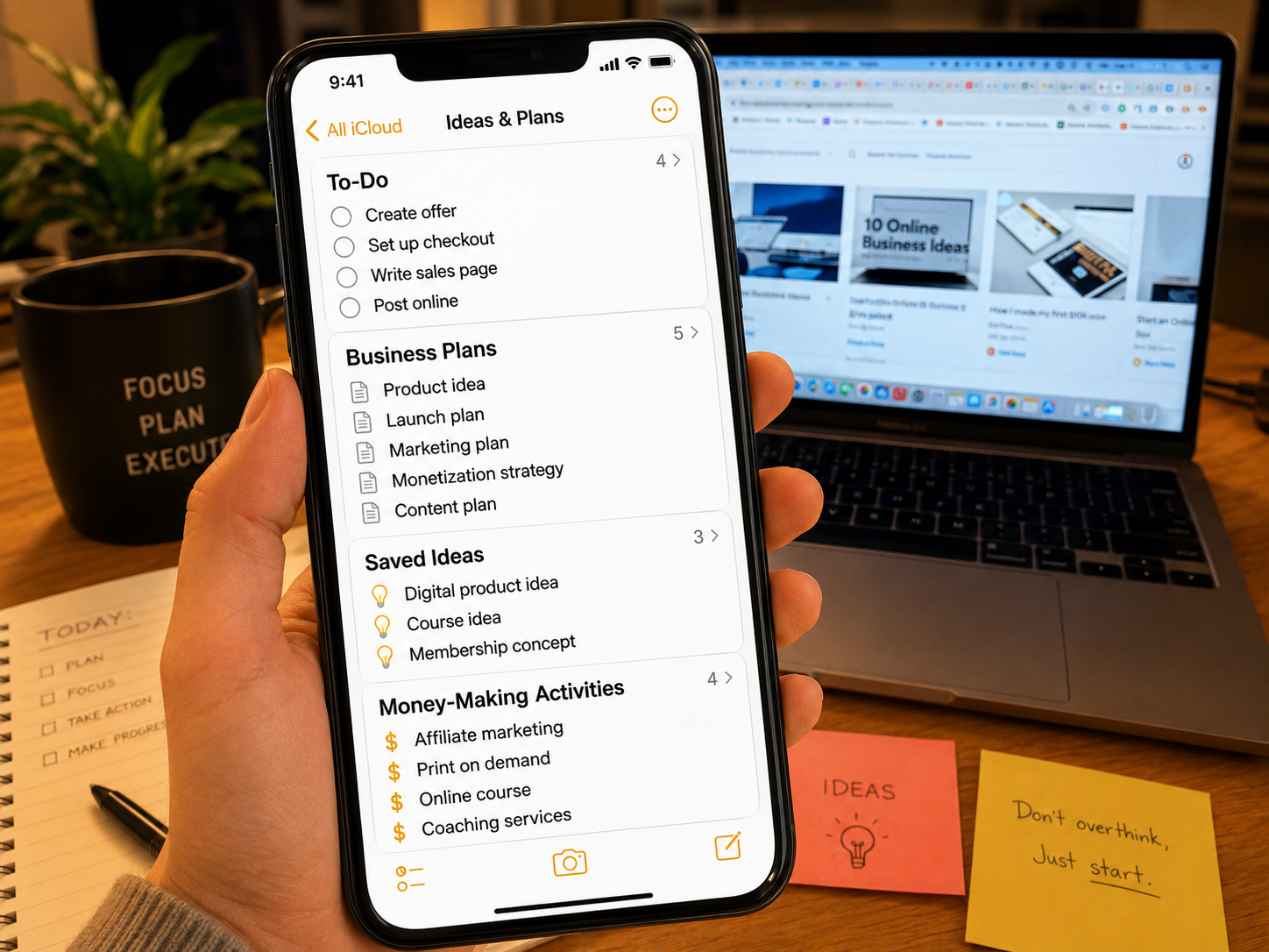Smartphone showing to do list business ideas and money making activities beside a laptop with open tabs